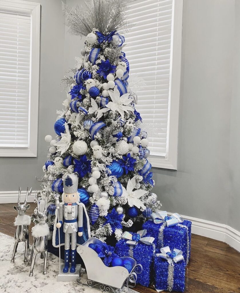 A blue and silver Christmas tree with butterflies and reindeer.