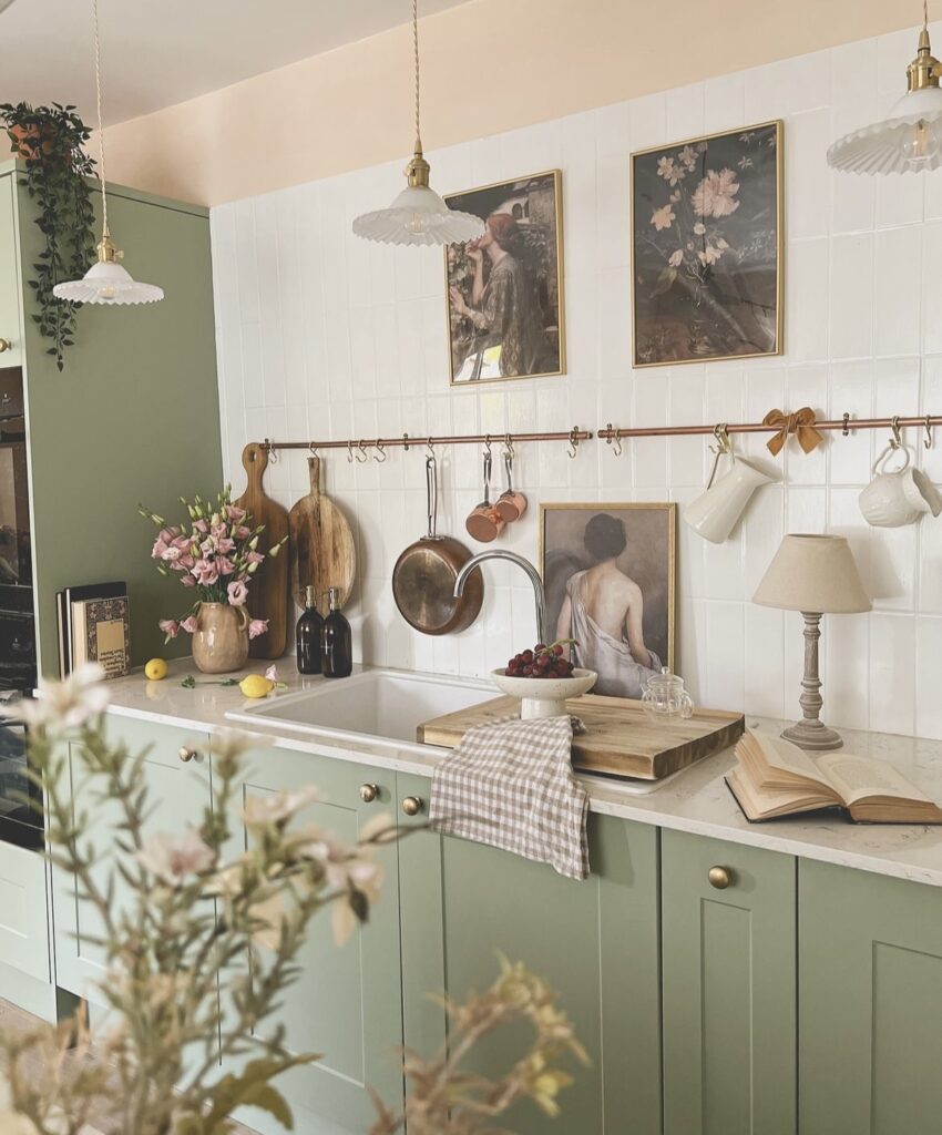 An antique kitchen with oil paintings and vintage pans.