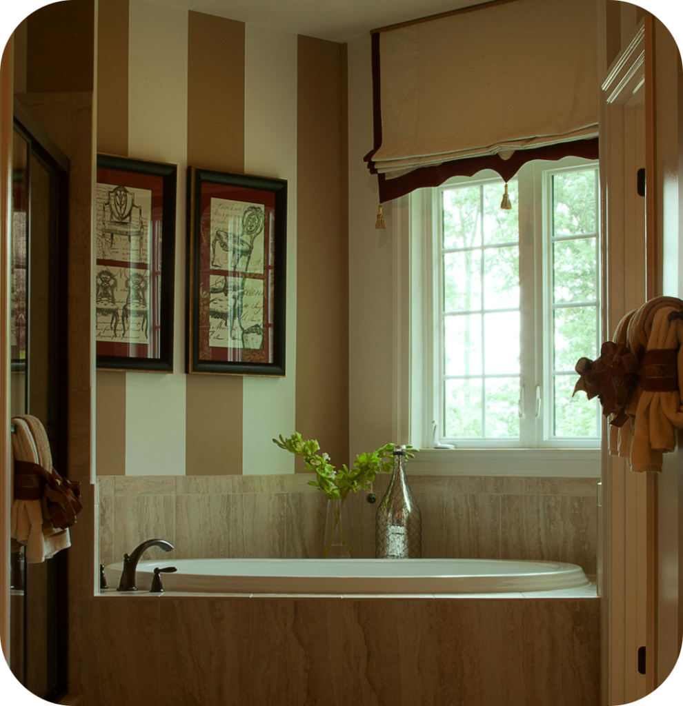 A bathroom with two framed prints depicting antique chairs.