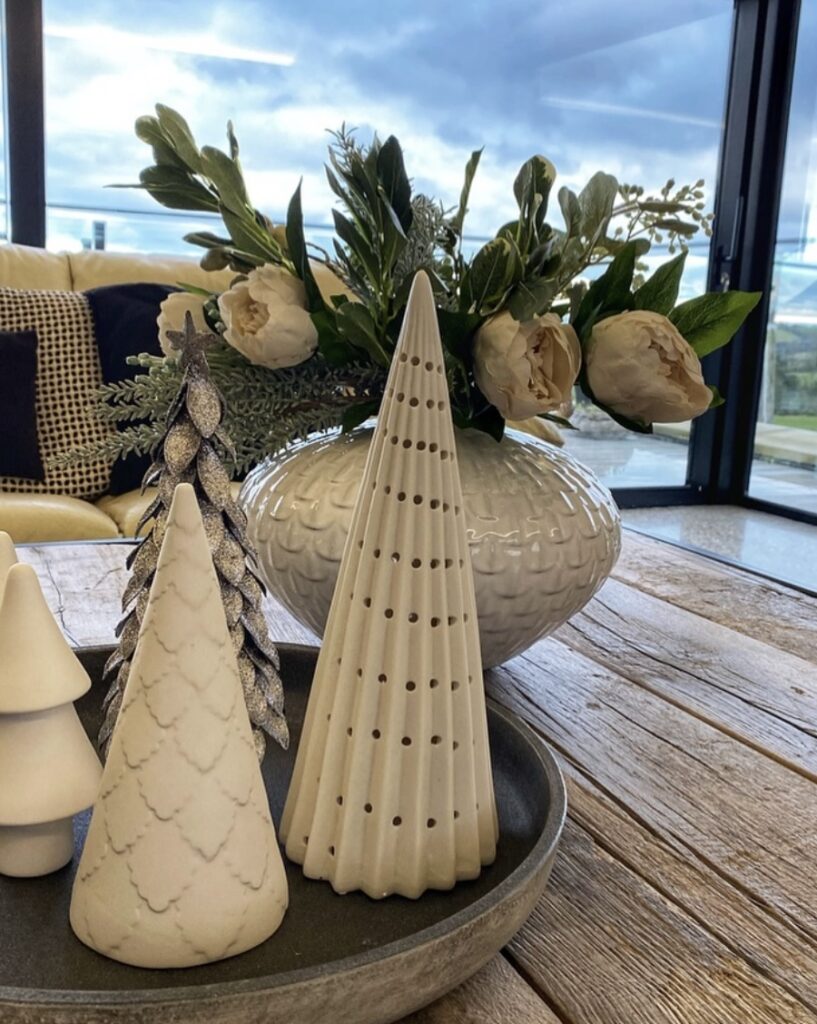 Ceramic white pine trees on a tray.