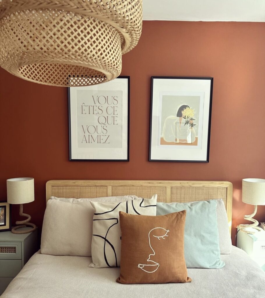 A warm bedroom with a terracotta wall.