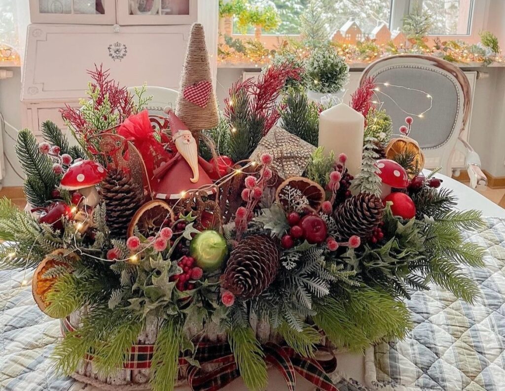 A Christmas centerpiece with a Santa Claus and pine branches.