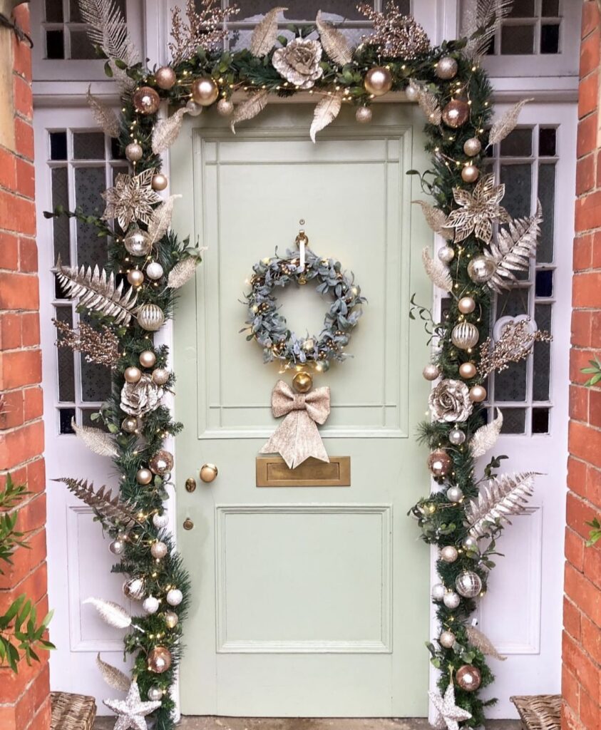 A pine branch garland with rose gold Christmas balls.