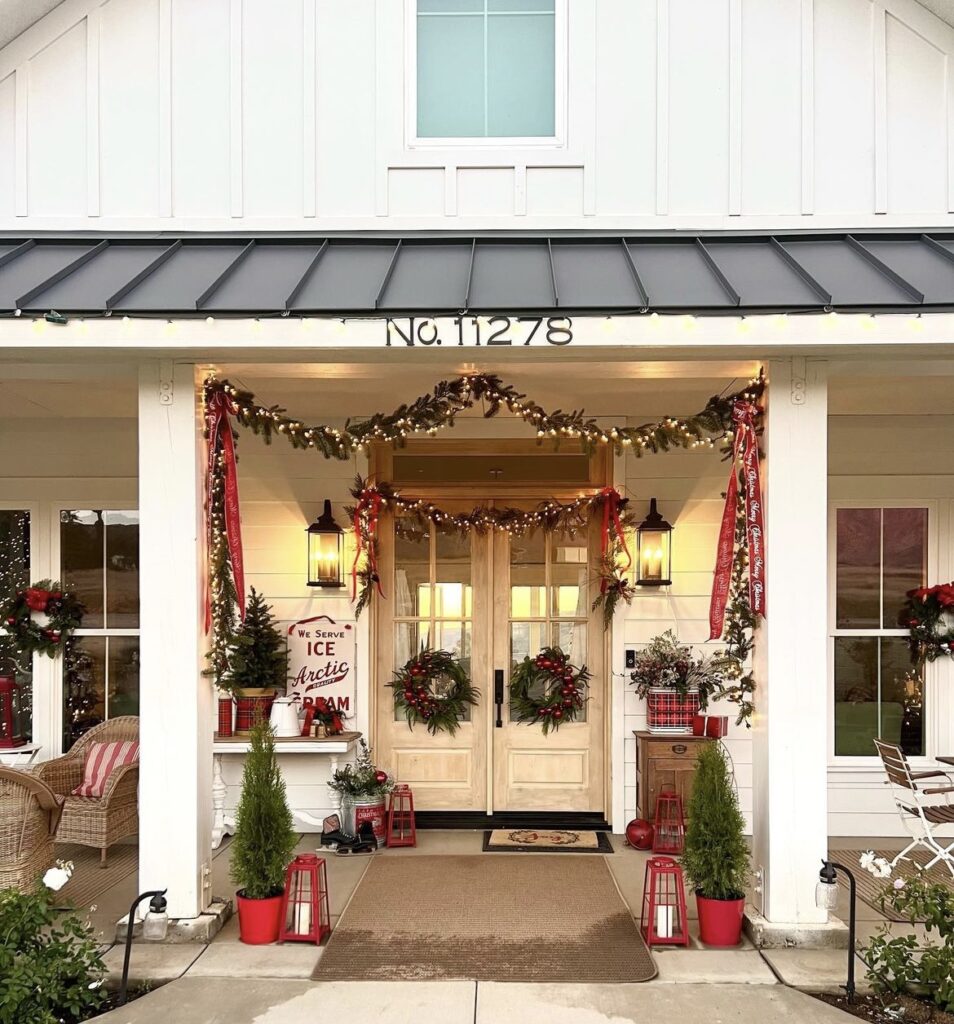 A Christmas porch with red decorations.