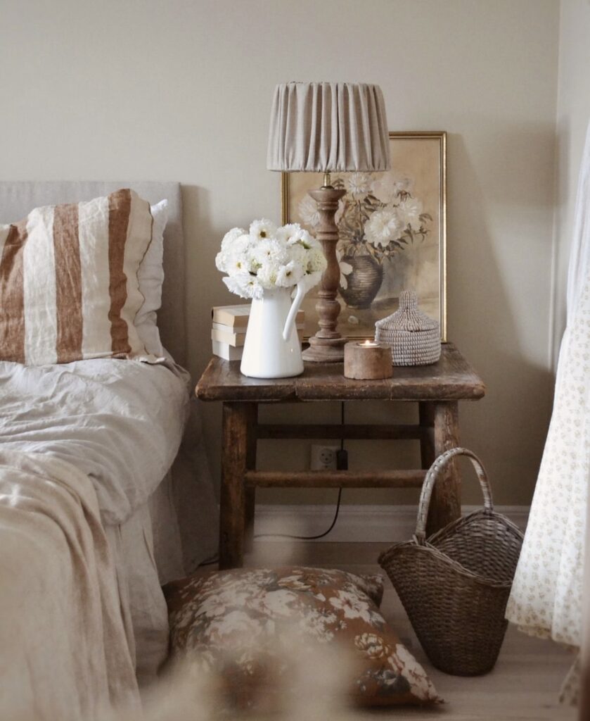 An elegant bedroom with a rustic nightstand table.