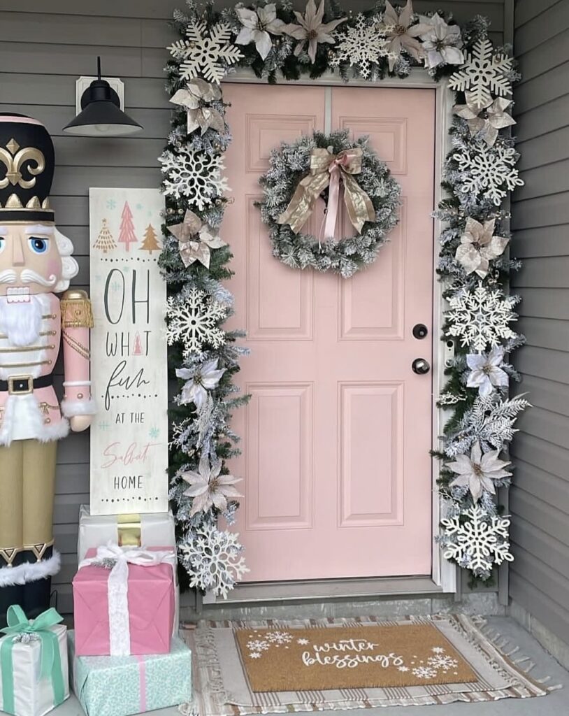 A pine branch garland with white poinsettias and snowflakes.