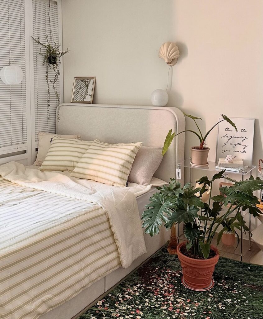 A modern bedroom with a floral rug and yellow bedding.