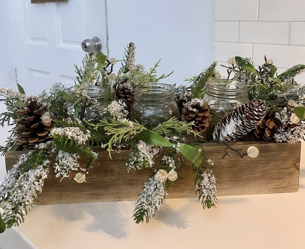 A Christmas centerpiece with pine branches and pine cones.