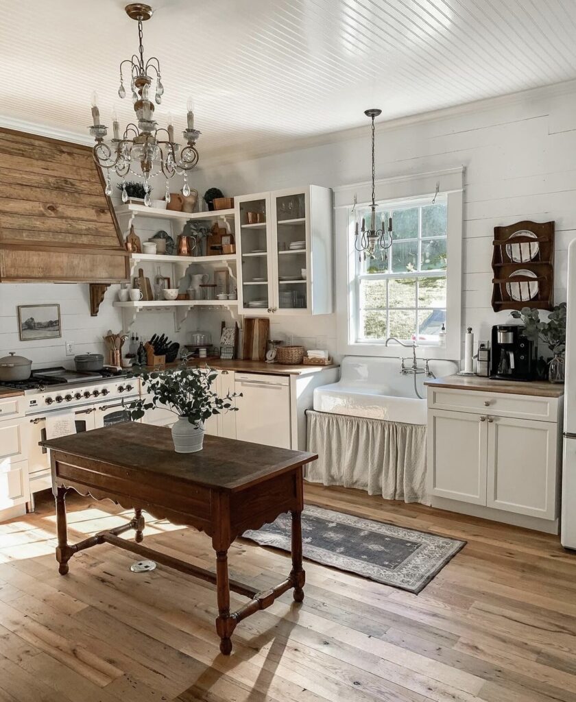 A farmhouse kitchen with an antique table as the kitchen island.