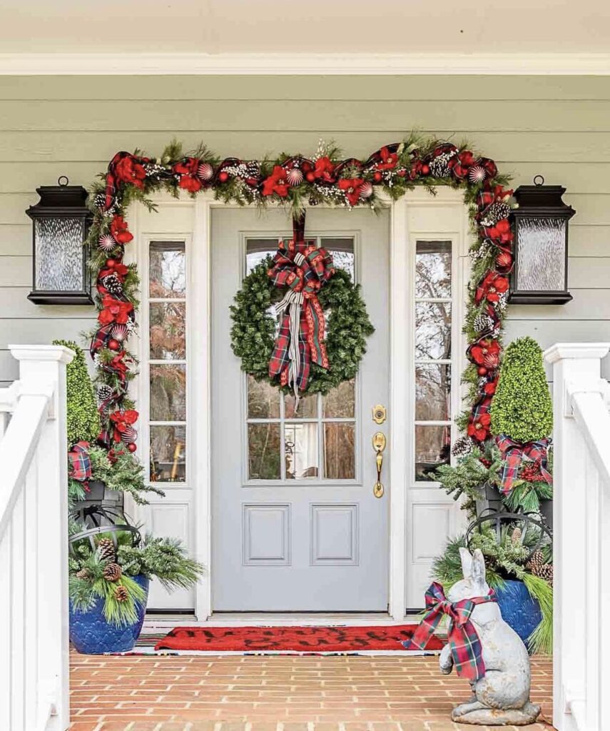 A pine branch garland with red ornaments.