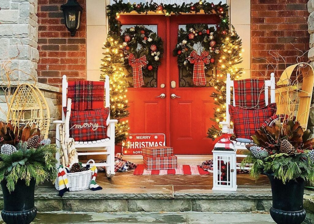 A Christmas porch with Christmas pillows.