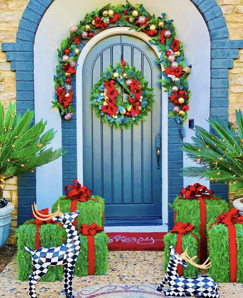 A Christmas porch with large reindeers.