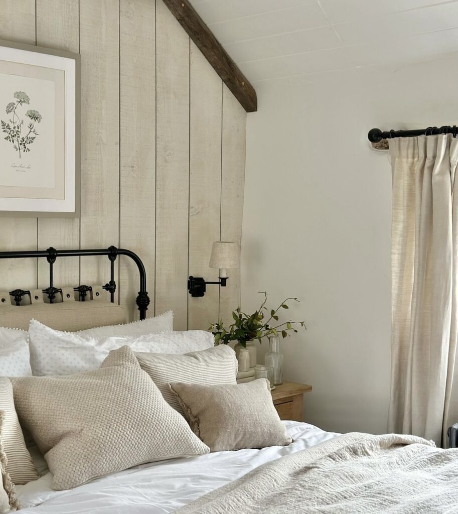 A farmhouse bedroom with black metal decorative items.