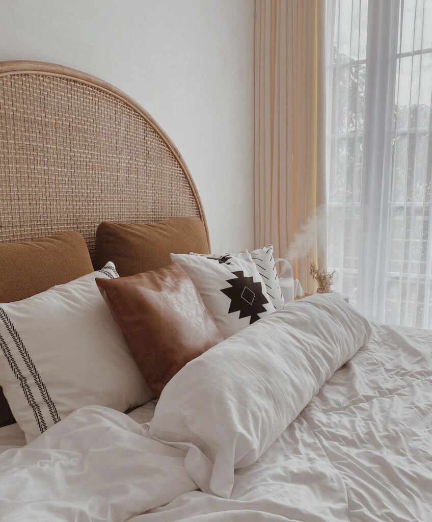 A bed with a woven headboard.