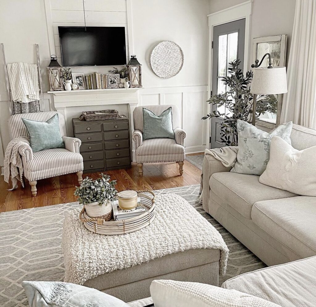 A cozy living room with comfortable chairs, sofa and pillows.