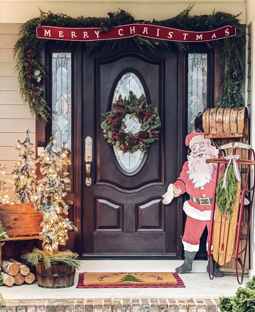 A Christmas porch with a Santa Claus wooden sign.