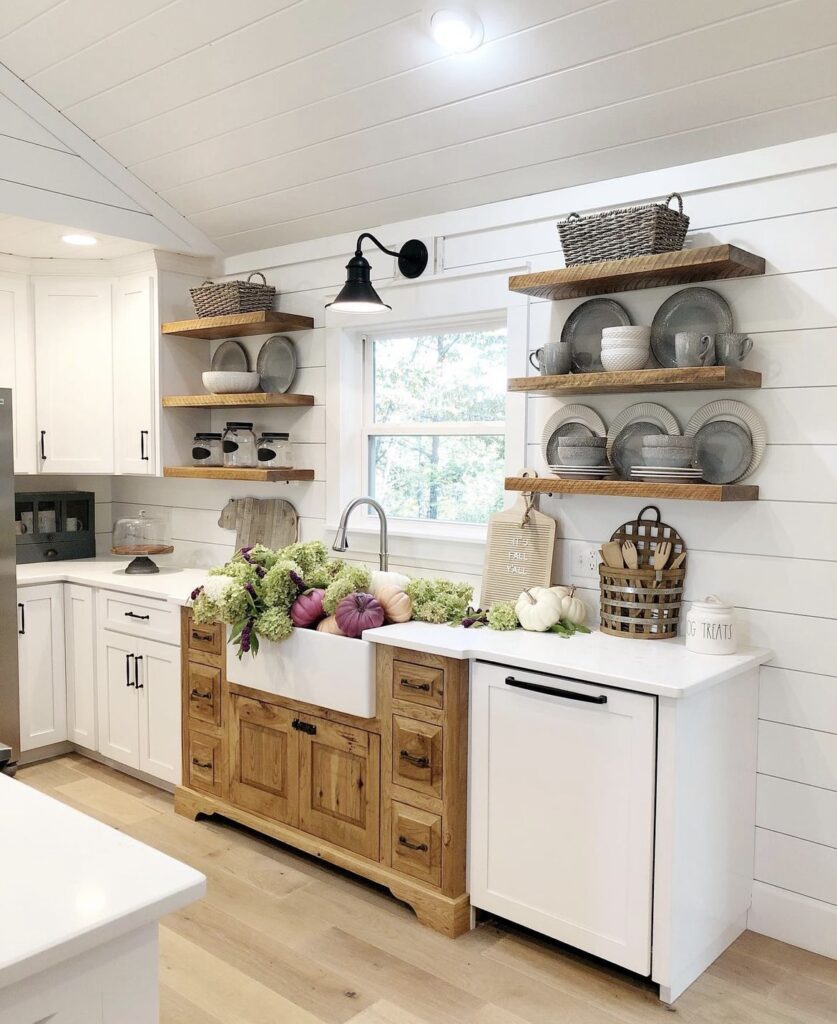 A farmhouse kitchen with wooden floating shelves.