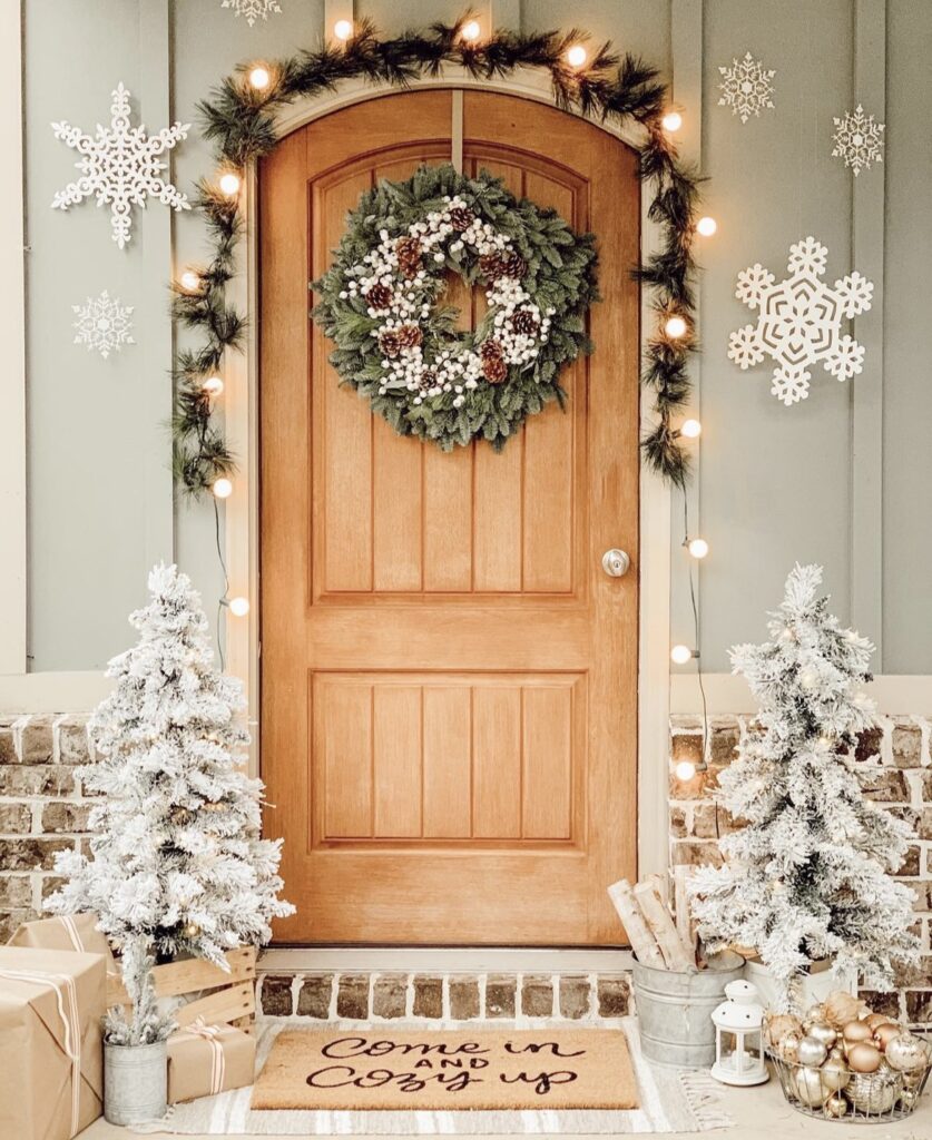 A Christmas porch with snowflake cutouts.