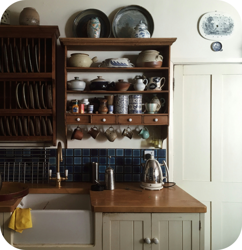 A farmhouse kitchen with a blue backsplash.