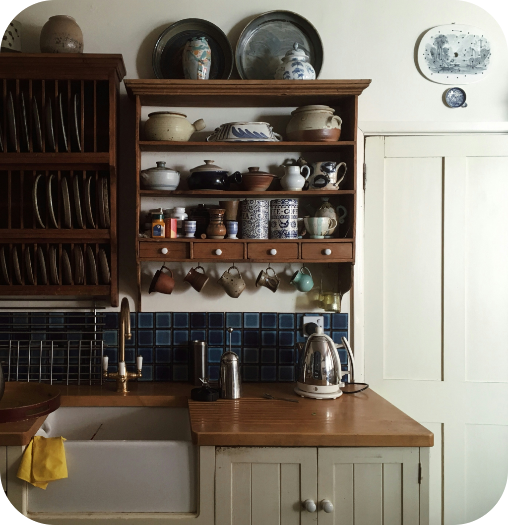A farmhouse kitchen with a blue backsplash.