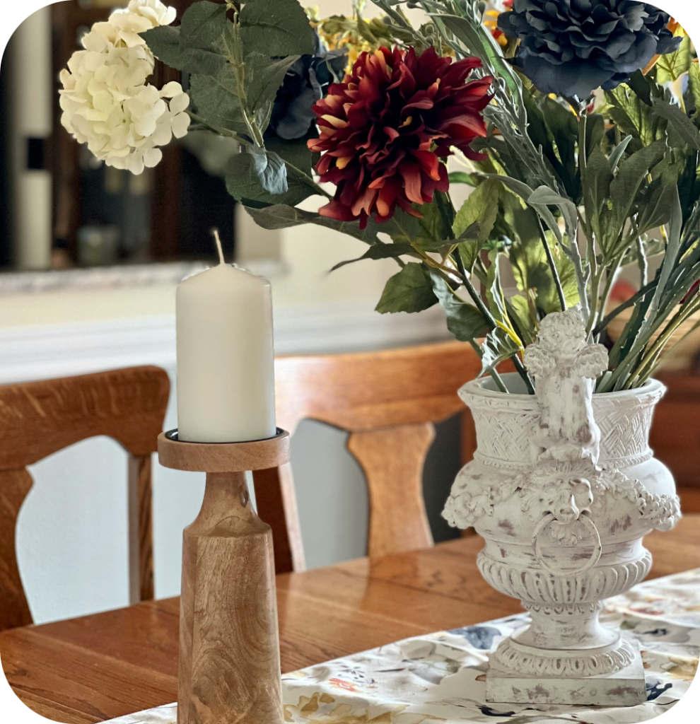 An antique white vase filled with flowers.