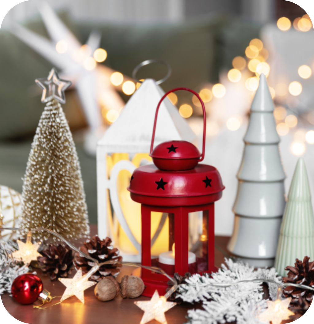 Mini pine trees with string lights, pine cones and a red candle lantern.
