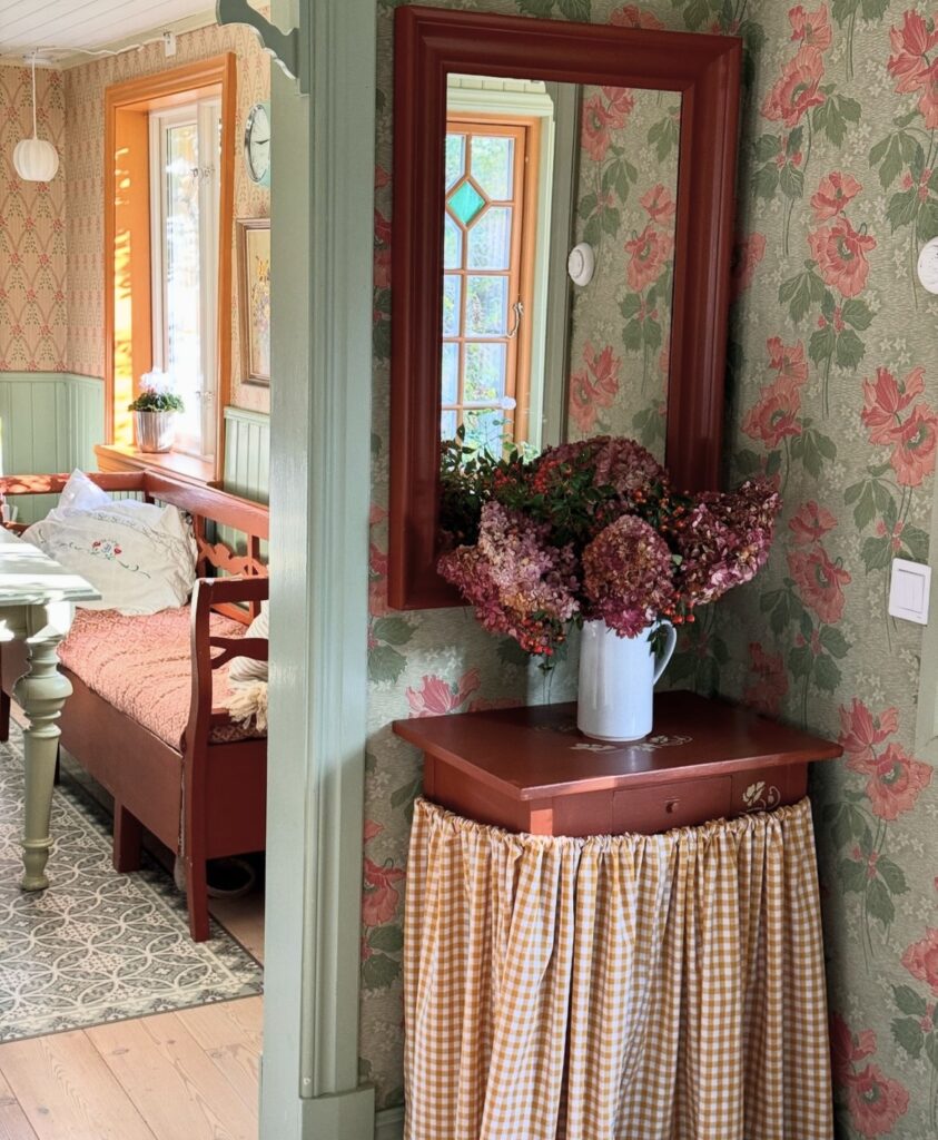 An antique mirror and furniture in a room's corner.