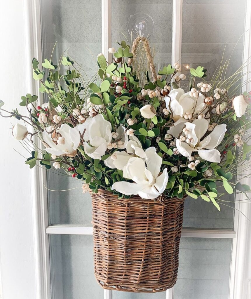 A woven vase with white flowers.