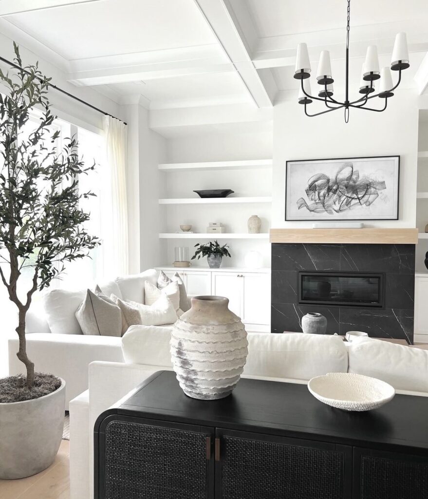 A black marble fireplace in a modern living room.