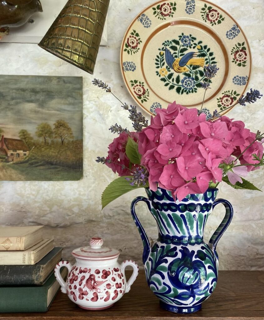 A patterned vase with a decorative plate.