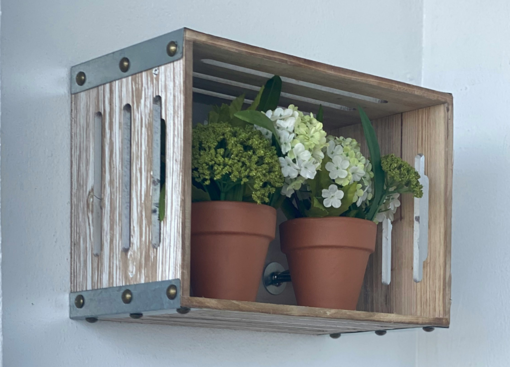 A wooden crate as a floating shelf.