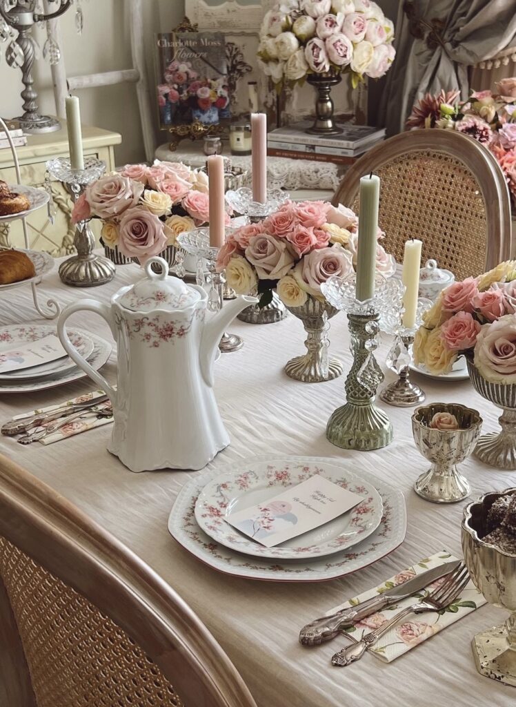 A centerpiece made of floral arrangements, taper candles and antique vases.