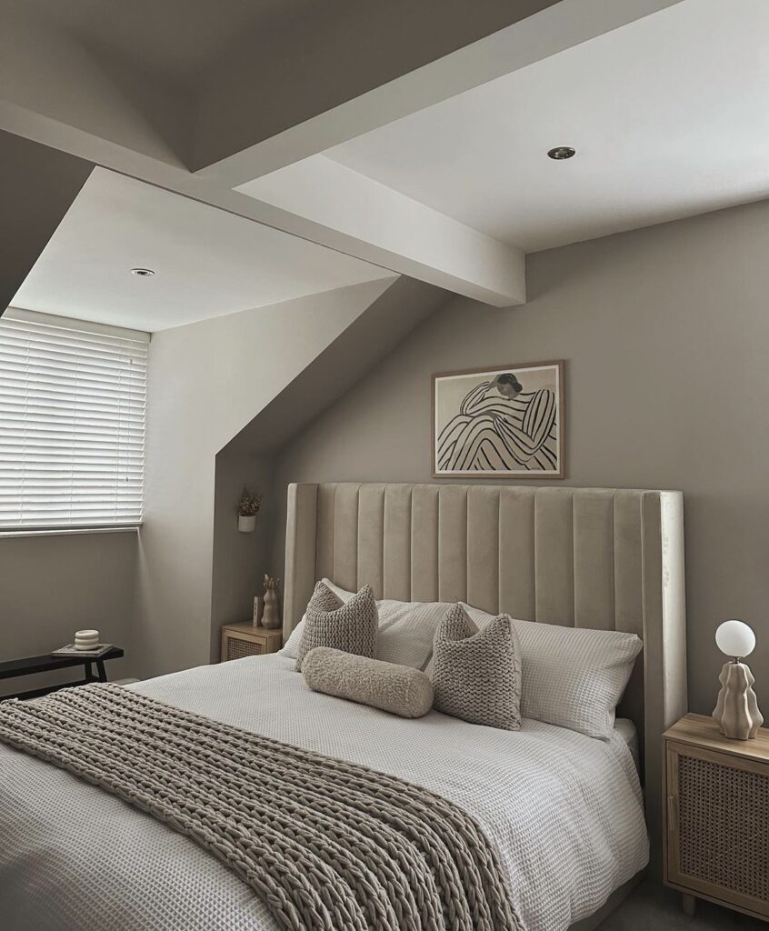 A neutral bedroom with a velvet headboard.