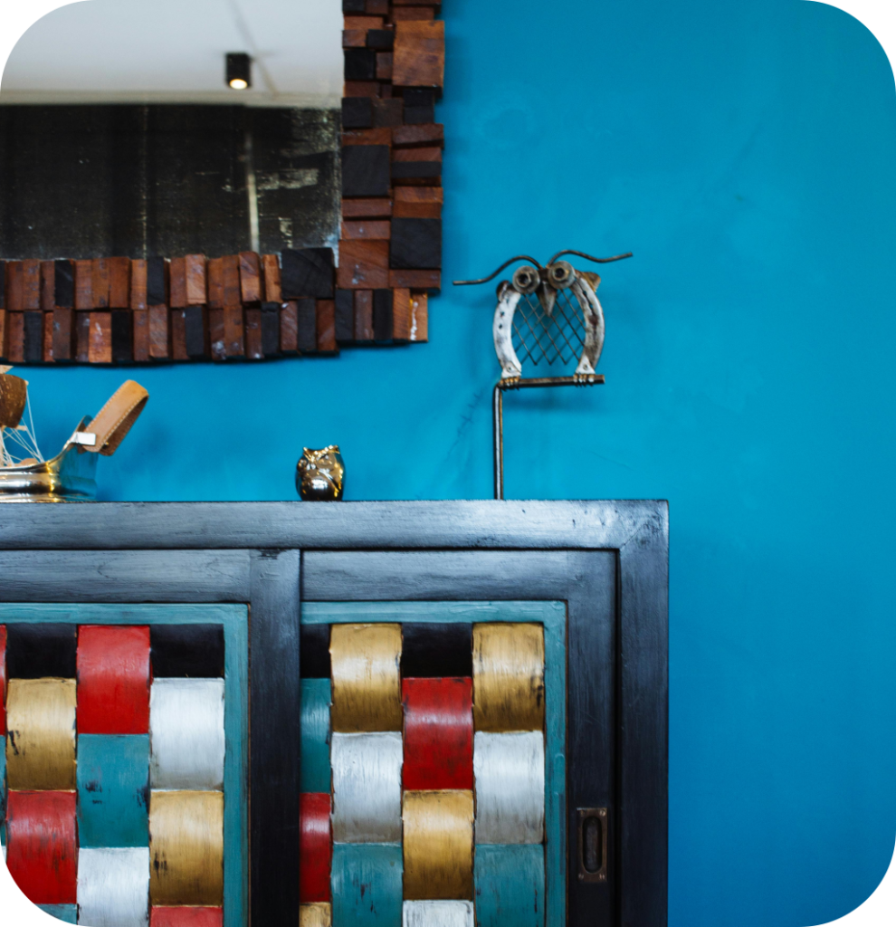 A colorful cabinet in a blue room.