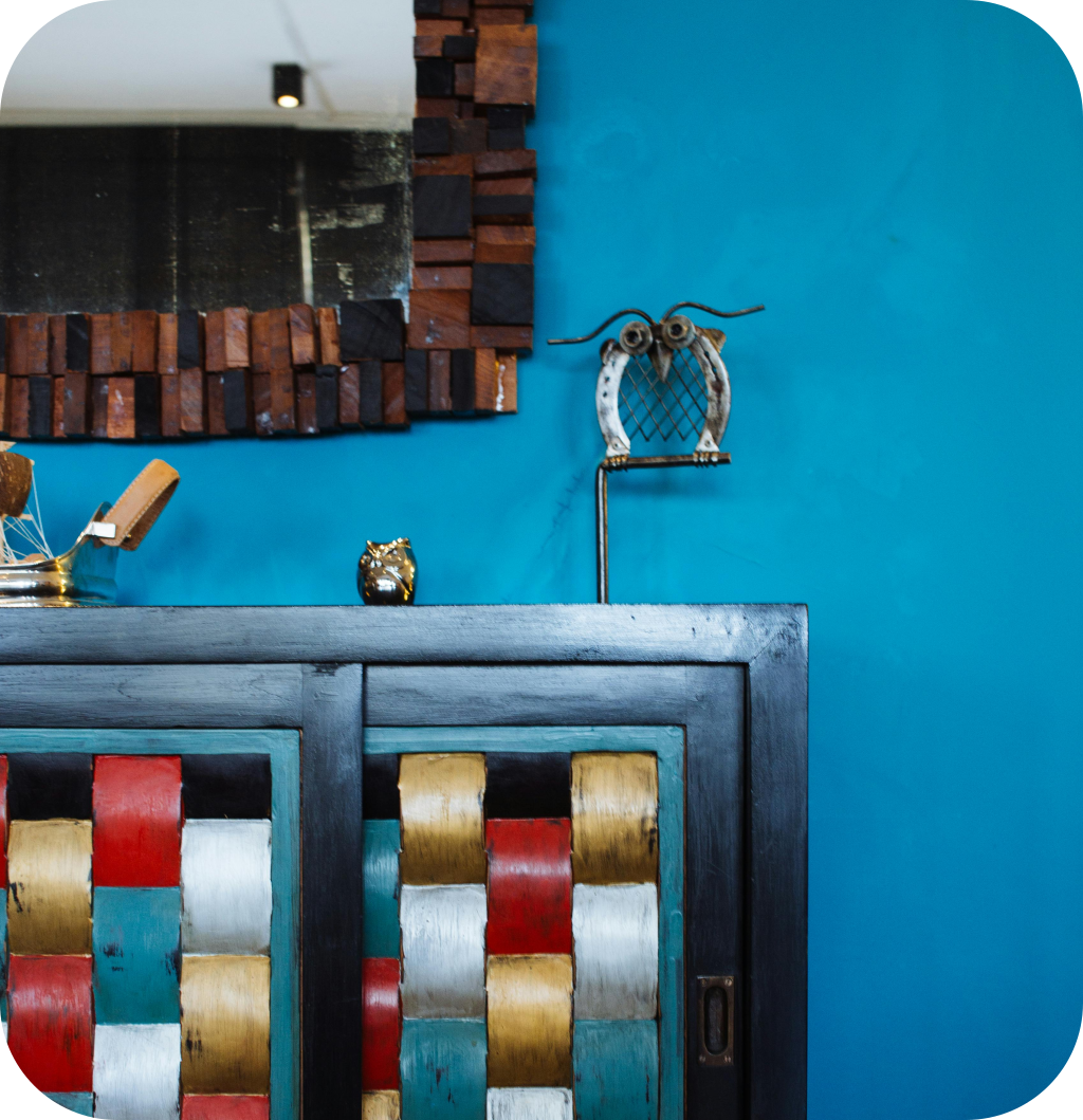A colorful cabinet in a blue room.