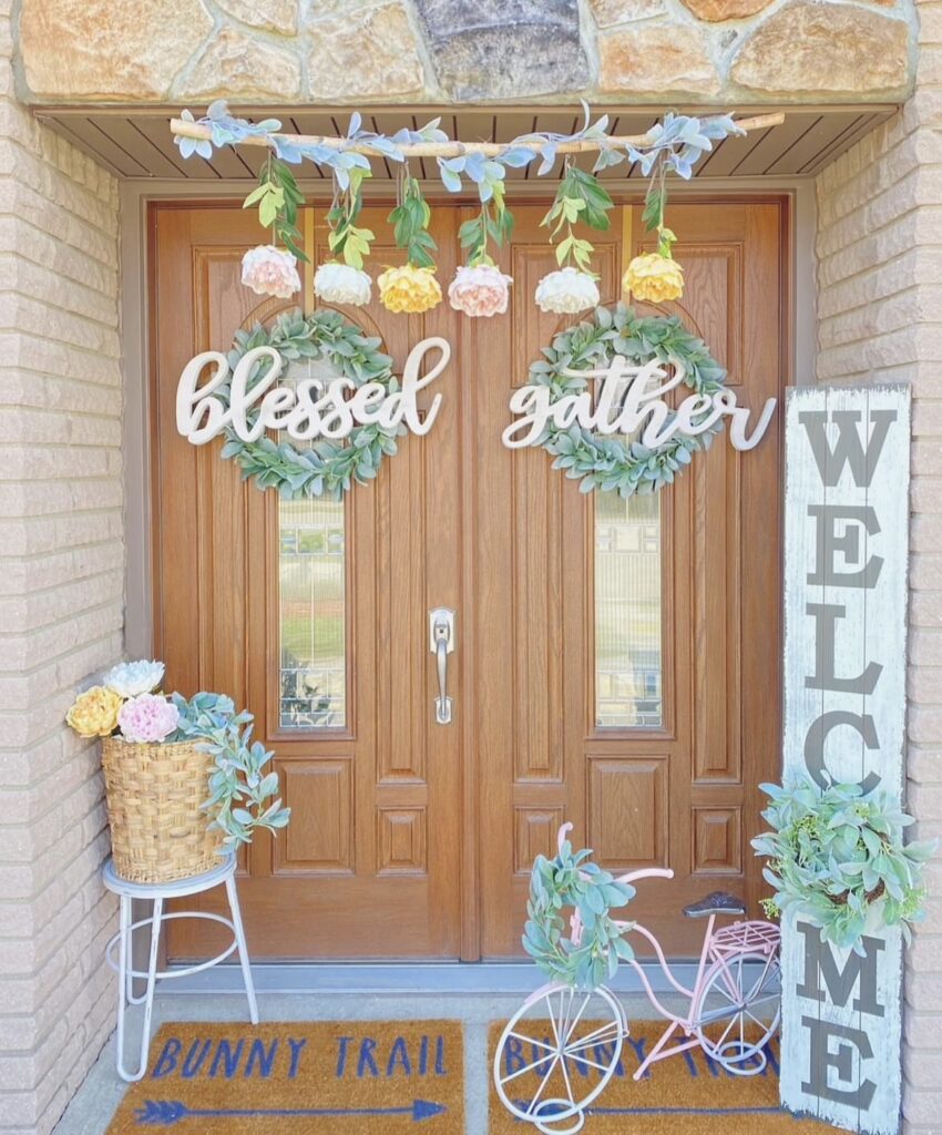 A eucalyptus wreath with a blessed sign on a wooden door.