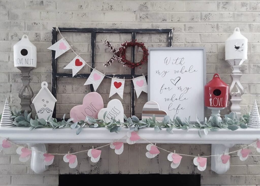 A mantel with Valentine garlands and heart cutouts.