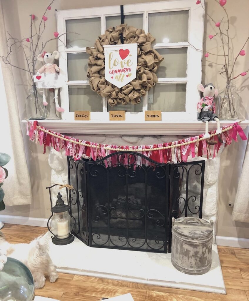 A mantel with Valentine garlands and a wreath.