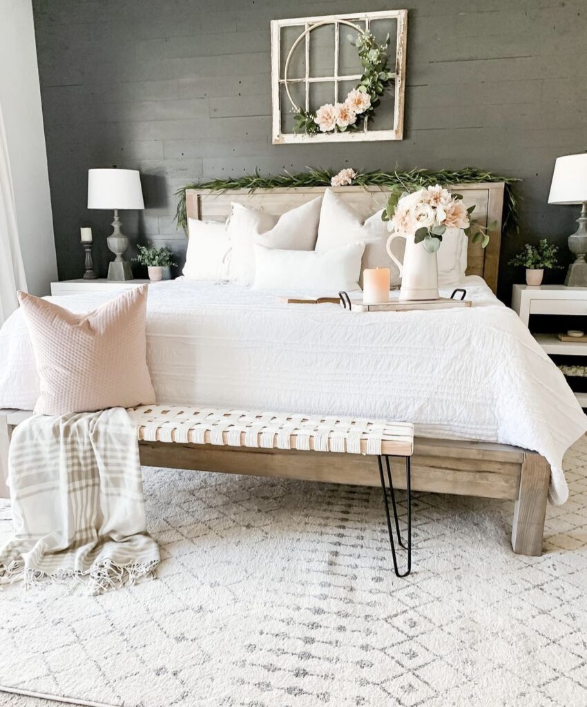 A floral wreath with a greenery garland in a bedroom.