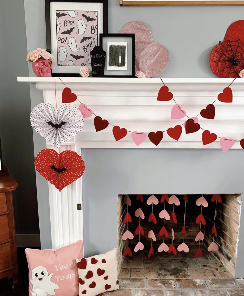 A mantel with Valentine garlands, bats and skulls.