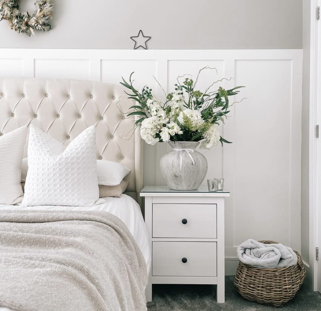 White flowers on a nightstand.