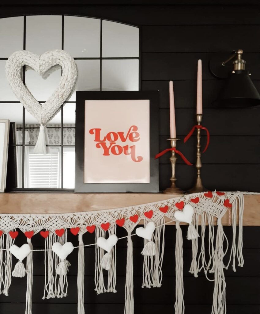 A mantel with lace garlands and taper candles.