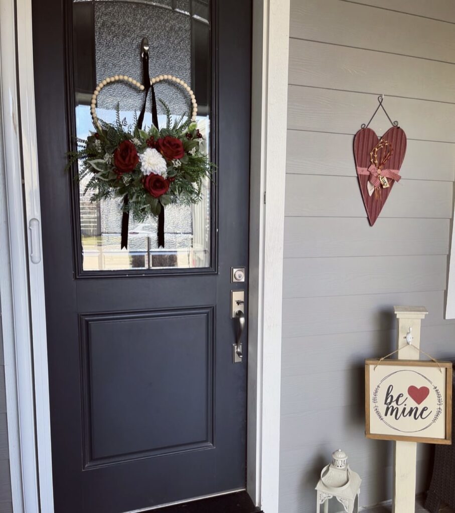 A front porch with a Valentine wreath.