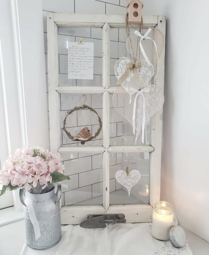 Lace hearts on a white distressed window frame.