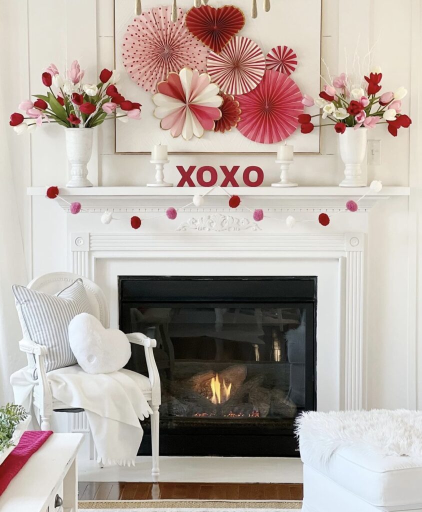 A mantel with Valentine paper fans.