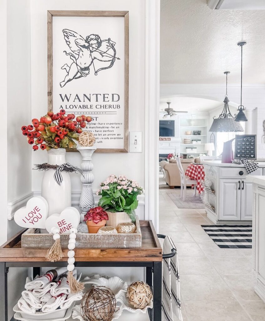 A Valentine entryway with a Cupid print, flowers, and heart cutouts.