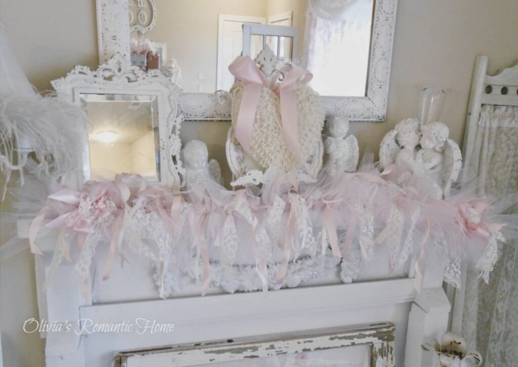 A mantel with angel figurines and lace garlands.