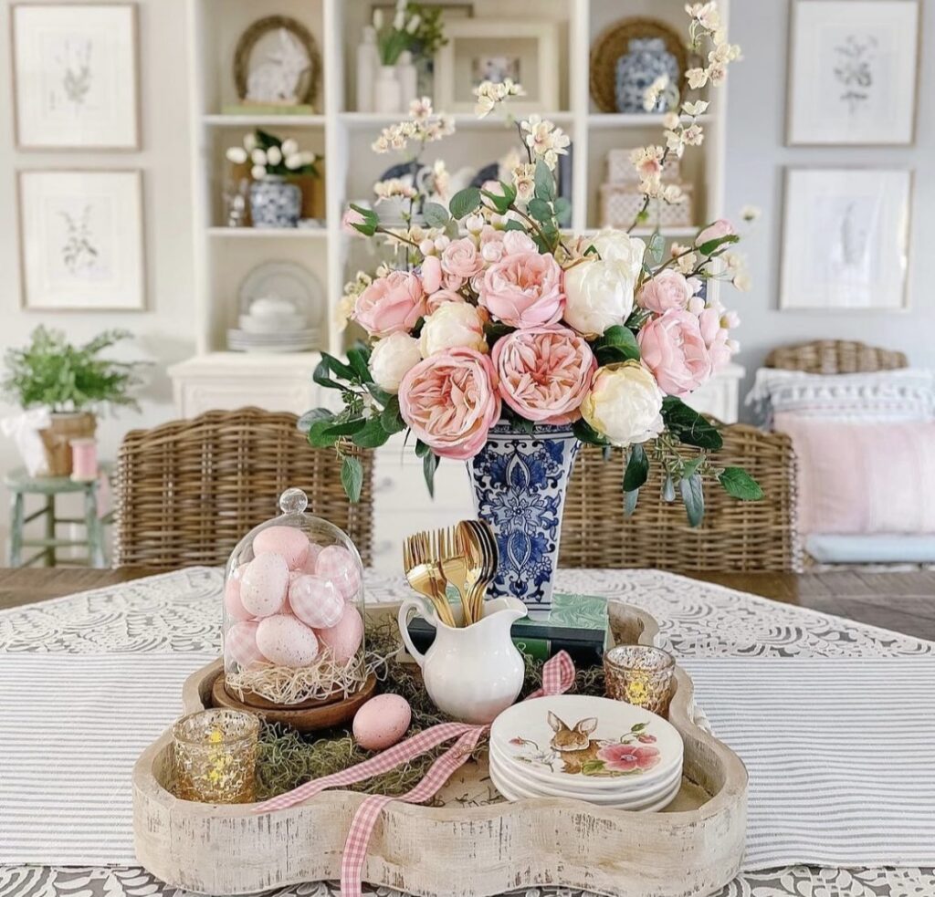 Easter eggs under a glass cloche on a wooden tray.