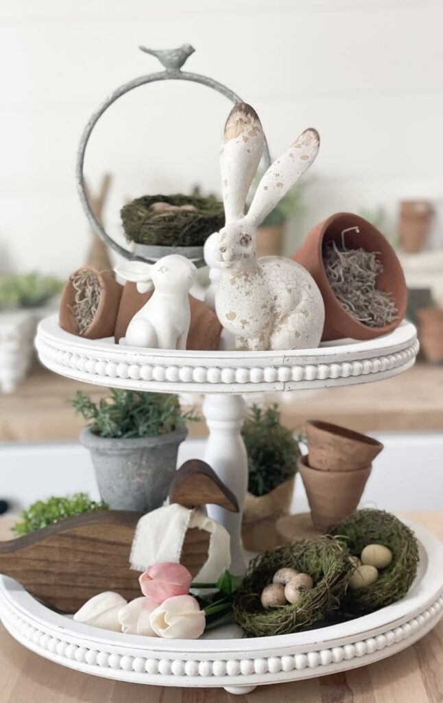 A spring tray with rabbit figurines and small planters.