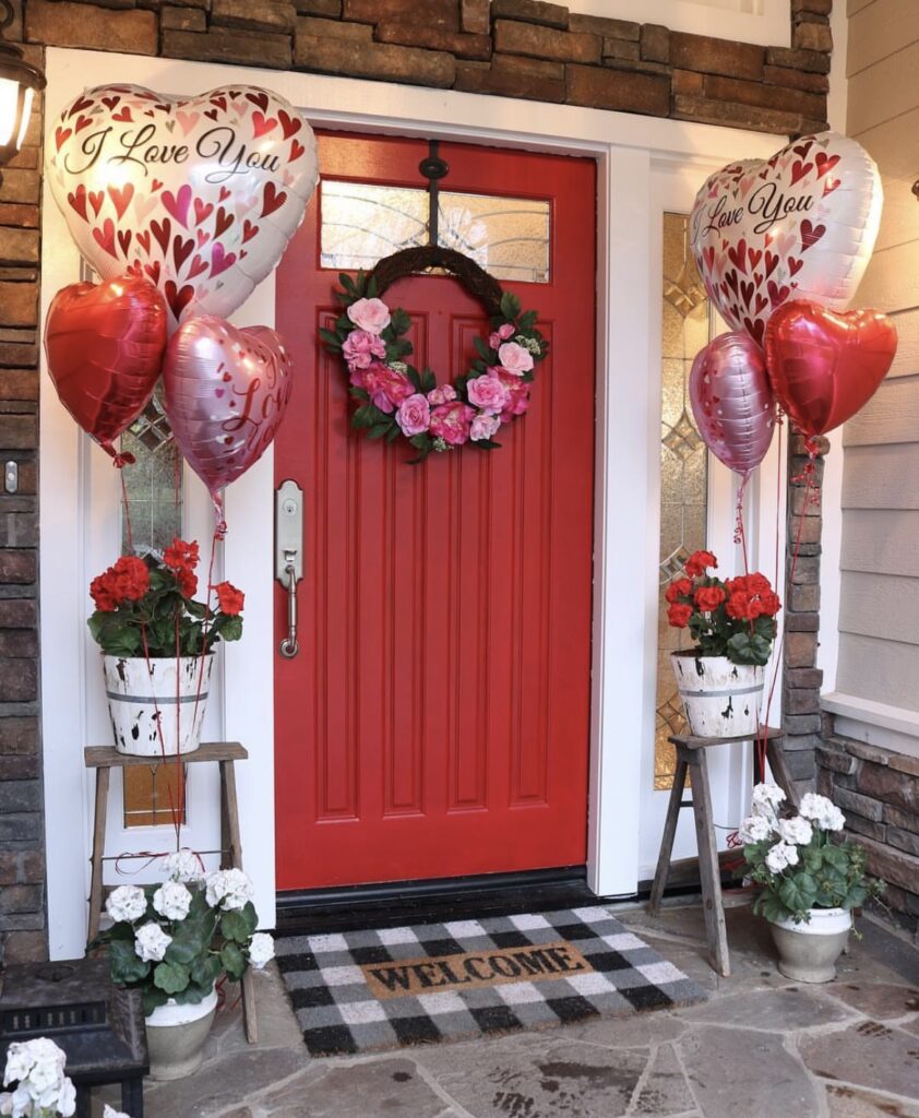 A front porch with heart balloons and a Valentine wreath.